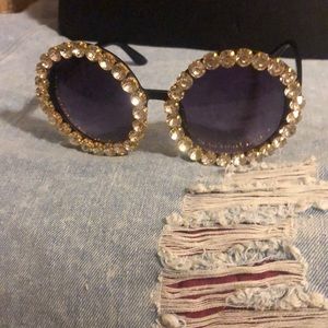 Round sunglasses with rhinestones on it